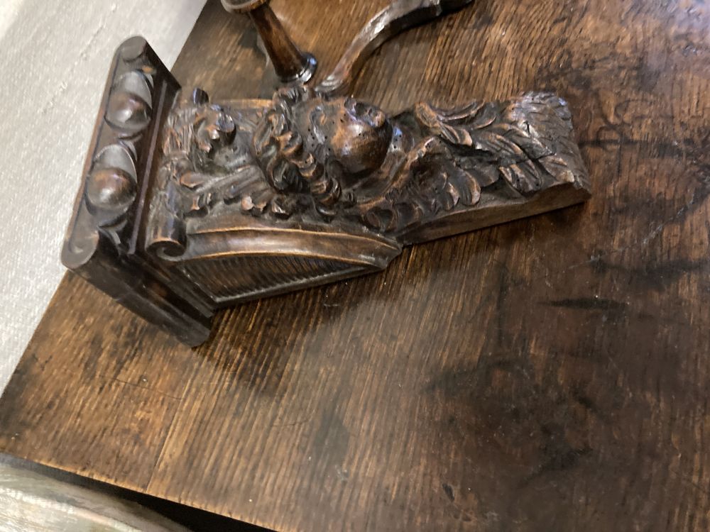 A carved oak eagle hanging coat rack, width 60cm, together with a carved walnut corbel, height 26cm